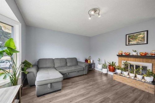 23 Edgedale Road Nw, Calgary, AB - Indoor Photo Showing Living Room With Fireplace