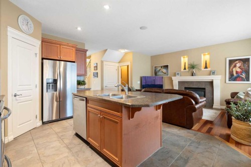 40 Bridleridge Lane Sw, Calgary, AB - Indoor Photo Showing Kitchen With Fireplace With Double Sink