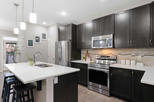 1529 Legacy Circle Se, Calgary, AB - Indoor Photo Showing Kitchen With Stainless Steel Kitchen With Double Sink With Upgraded Kitchen