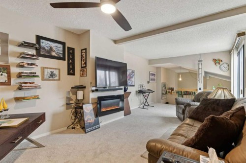 302-2425 90 Avenue Sw, Calgary, AB - Indoor Photo Showing Living Room With Fireplace