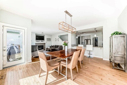 98 Mahogany Way Se, Calgary, AB - Indoor Photo Showing Dining Room With Fireplace