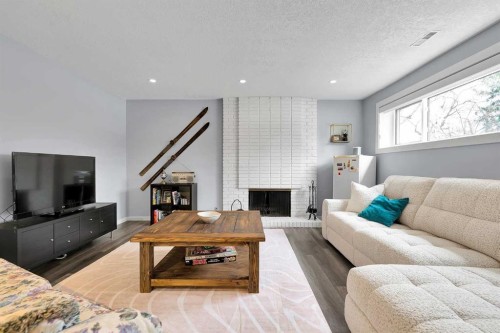 6584 Dalrymple Way Nw, Calgary, AB - Indoor Photo Showing Living Room With Fireplace