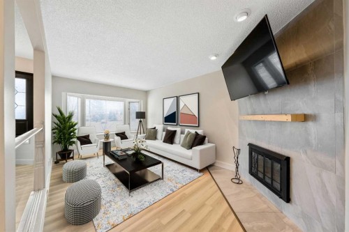 100 Woodfield Green Sw, Calgary, AB - Indoor Photo Showing Living Room With Fireplace