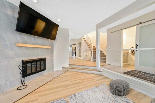 100 Woodfield Green Sw, Calgary, AB - Indoor With Fireplace