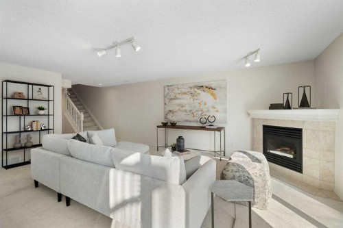 100 Hamptons Link Nw, Calgary, AB - Indoor Photo Showing Living Room With Fireplace