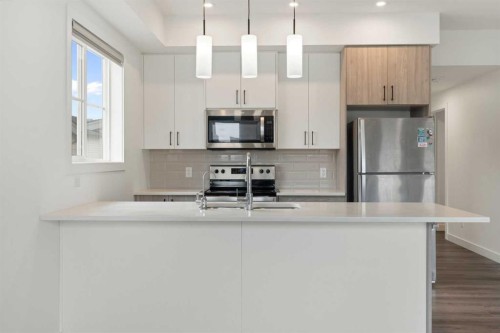 122 Spring Creek Common Sw, Calgary, AB - Indoor Photo Showing Kitchen With Double Sink With Upgraded Kitchen