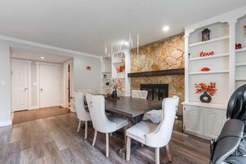 80 Taylor Way Se, Airdrie, AB - Indoor Photo Showing Dining Room With Fireplace