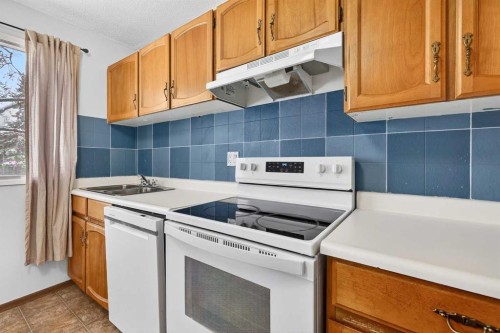 1502 Ranchlands Way Nw, Calgary, AB - Indoor Photo Showing Kitchen With Double Sink