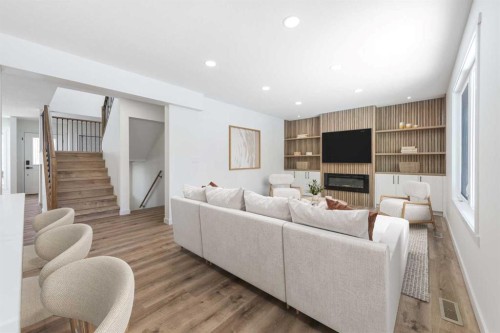 307 Hamptons Mews Nw, Calgary, AB - Indoor Photo Showing Living Room With Fireplace