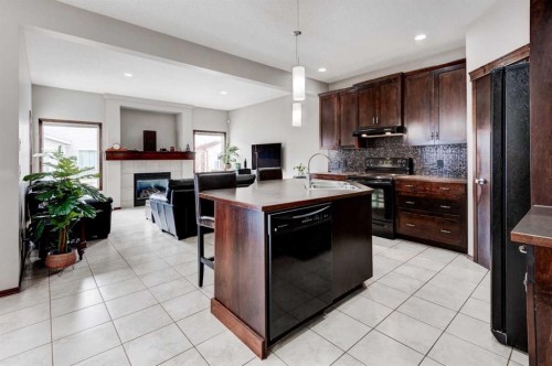 42 Everoak Green Sw, Calgary, AB - Indoor Photo Showing Kitchen With Fireplace