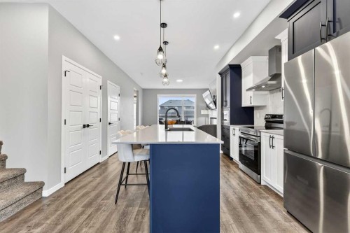 94 Wolf Gate Nw, Okotoks, AB - Indoor Photo Showing Kitchen With Stainless Steel Kitchen With Upgraded Kitchen