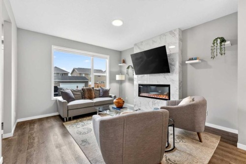 94 Wolf Gate Nw, Okotoks, AB - Indoor Photo Showing Living Room With Fireplace
