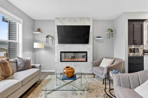 94 Wolf Gate Nw, Okotoks, AB - Indoor Photo Showing Living Room With Fireplace