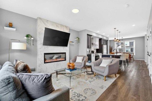 94 Wolf Gate Nw, Okotoks, AB - Indoor Photo Showing Living Room With Fireplace