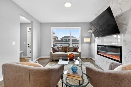 94 Wolf Gate Nw, Okotoks, AB - Indoor Photo Showing Living Room With Fireplace