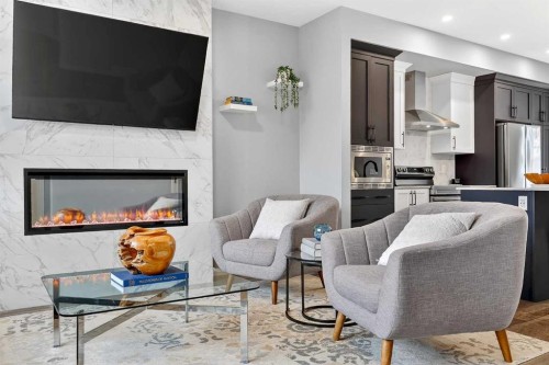 94 Wolf Gate Nw, Okotoks, AB - Indoor Photo Showing Living Room With Fireplace
