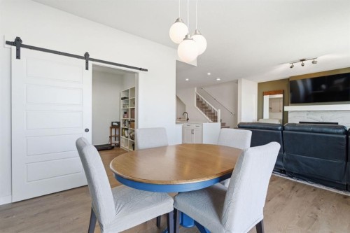 459 Rivercrest Road, Cochrane, AB - Indoor Photo Showing Dining Room With Fireplace