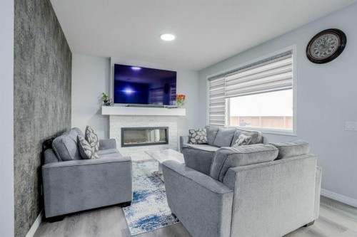673 Corner Meadows Way Ne, Calgary, AB - Indoor Photo Showing Living Room With Fireplace