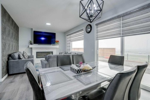 673 Corner Meadows Way Ne, Calgary, AB - Indoor Photo Showing Dining Room With Fireplace