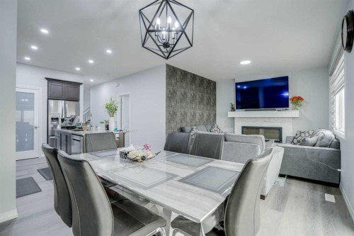 673 Corner Meadows Way Ne, Calgary, AB - Indoor Photo Showing Dining Room With Fireplace