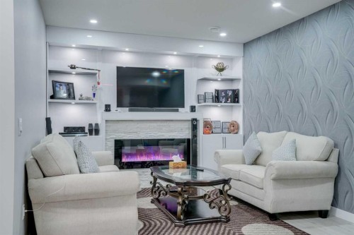 673 Corner Meadows Way Ne, Calgary, AB - Indoor Photo Showing Living Room With Fireplace