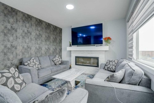 673 Corner Meadows Way Ne, Calgary, AB - Indoor Photo Showing Living Room With Fireplace