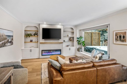 76 Stradbrooke Way Sw, Calgary, AB - Indoor Photo Showing Living Room With Fireplace