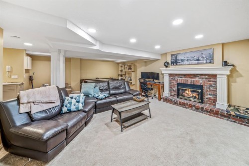 76 Stradbrooke Way Sw, Calgary, AB - Indoor Photo Showing Other Room With Fireplace