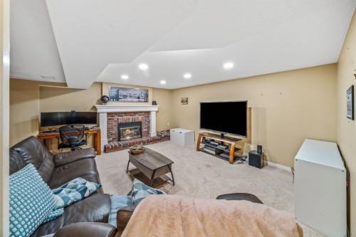 76 Stradbrooke Way Sw, Calgary, AB - Indoor With Fireplace