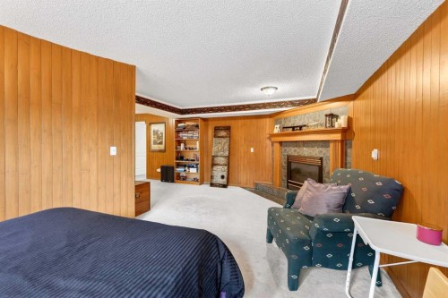 8 Somerset Gate Sw, Calgary, AB - Indoor Photo Showing Bedroom With Fireplace