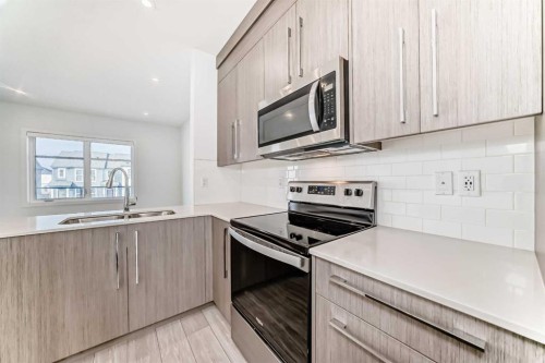 693 Savanna Boulevard Ne, Calgary, AB - Indoor Photo Showing Kitchen With Stainless Steel Kitchen With Double Sink With Upgraded Kitchen