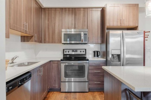 1216-215 Legacy Boulevard Se, Calgary, AB - Indoor Photo Showing Kitchen With Stainless Steel Kitchen With Double Sink With Upgraded Kitchen