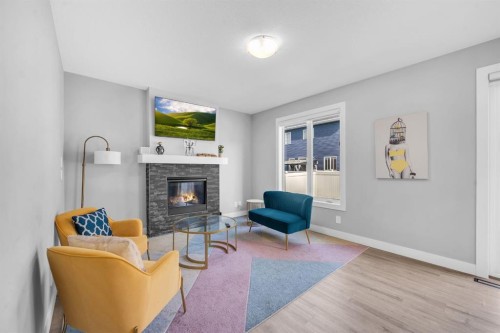 155 Carringham Way Nw, Calgary, AB - Indoor Photo Showing Living Room With Fireplace