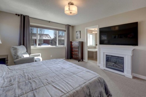 38 Cranbrook Place Se, Calgary, AB - Indoor Photo Showing Bedroom With Fireplace