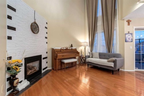 27 Arbour Butte Road Nw, Calgary, AB - Indoor Photo Showing Other Room With Fireplace