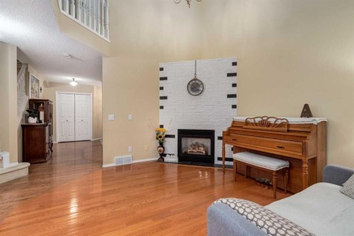 27 Arbour Butte Road Nw, Calgary, AB - Indoor Photo Showing Living Room With Fireplace