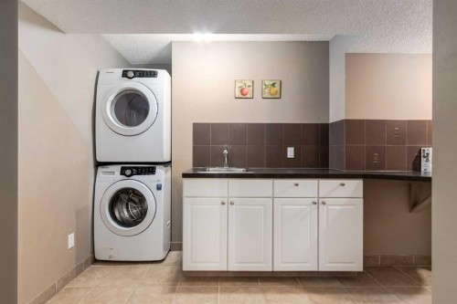 27 Arbour Butte Road Nw, Calgary, AB - Indoor Photo Showing Laundry Room