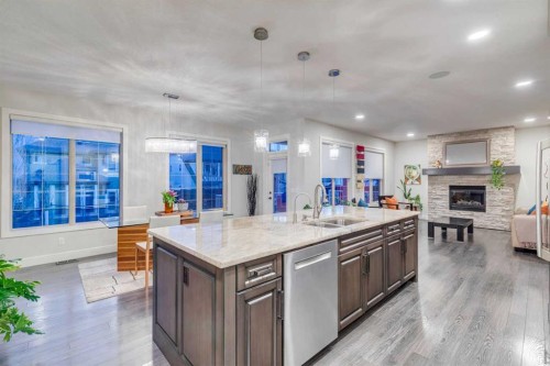 61 Masters Landing Se, Calgary, AB - Indoor Photo Showing Kitchen With Fireplace With Double Sink
