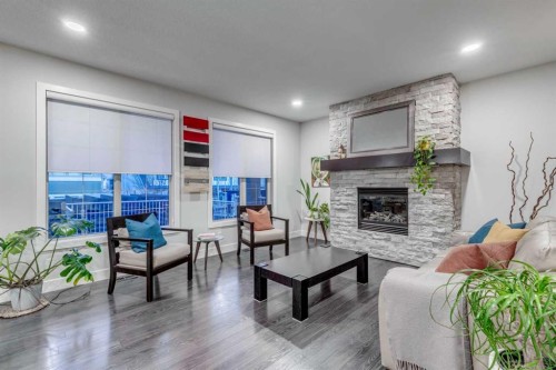 61 Masters Landing Se, Calgary, AB - Indoor Photo Showing Living Room With Fireplace