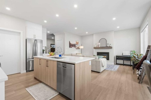 60 Ranchers View, Okotoks, AB - Indoor Photo Showing Kitchen With Fireplace With Stainless Steel Kitchen With Upgraded Kitchen
