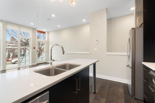 102-1808 27 Avenue Sw, Calgary, AB - Indoor Photo Showing Kitchen With Stainless Steel Kitchen With Double Sink With Upgraded Kitchen