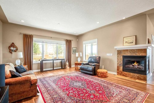341 1 Avenue Se, Diamond Valley, AB - Indoor Photo Showing Living Room With Fireplace