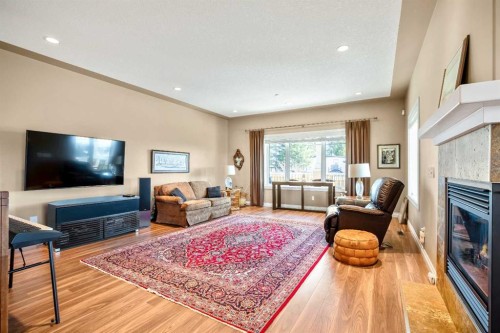 341 1 Avenue Se, Diamond Valley, AB - Indoor Photo Showing Living Room With Fireplace