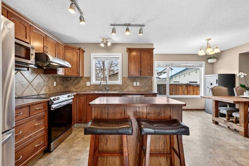 57 Everridge Way Sw, Calgary, AB - Indoor Photo Showing Kitchen With Stainless Steel Kitchen With Double Sink