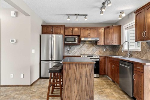 57 Everridge Way Sw, Calgary, AB - Indoor Photo Showing Kitchen With Stainless Steel Kitchen With Double Sink
