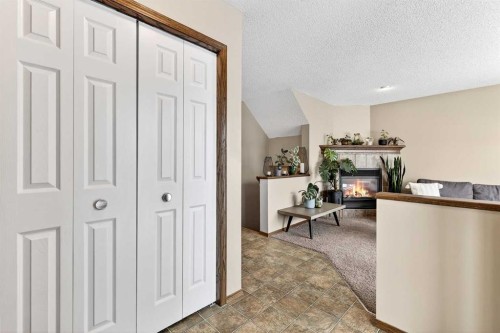 57 Everridge Way Sw, Calgary, AB - Indoor Photo Showing Other Room With Fireplace