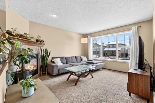 57 Everridge Way Sw, Calgary, AB - Indoor Photo Showing Living Room With Fireplace