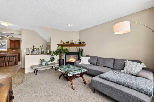 57 Everridge Way Sw, Calgary, AB - Indoor Photo Showing Living Room With Fireplace