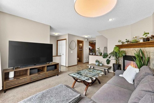 57 Everridge Way Sw, Calgary, AB - Indoor Photo Showing Living Room With Fireplace
