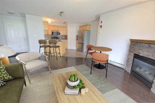 1207-7451 Springbank Boulevard Sw, Calgary, AB - Indoor Photo Showing Living Room With Fireplace